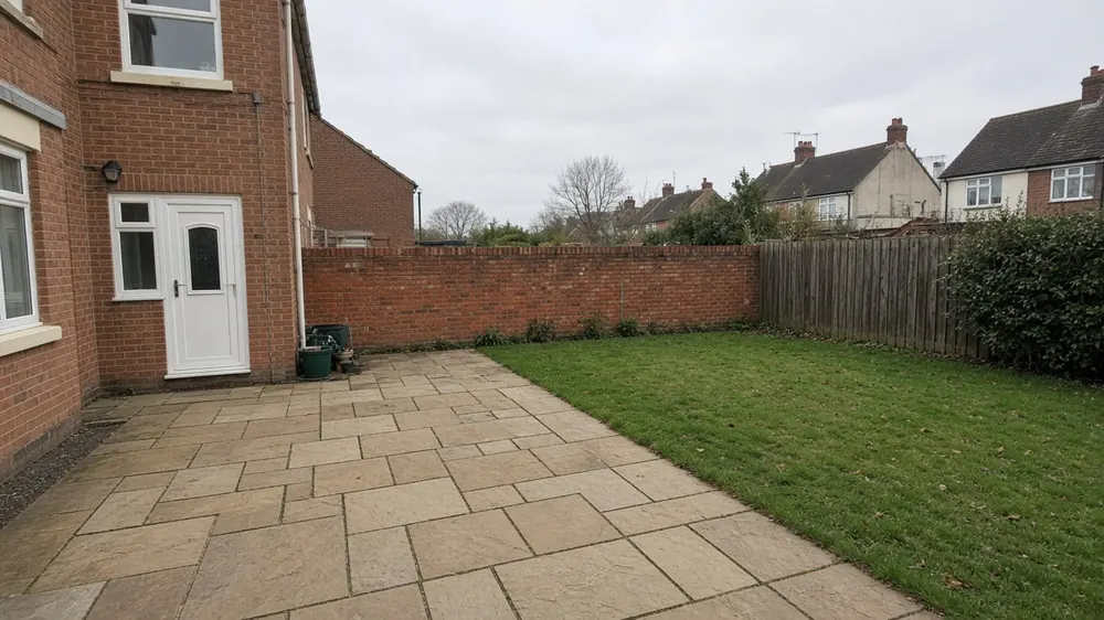 Example image: riven sandstone patio with a low brick wall in the back garden of a semi-detached house near the coast
